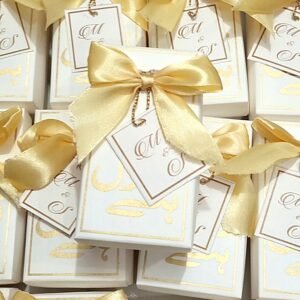 These beautifully crafted bid box favor boxes are designed to add a special touch to any event. From elegant gold boxes with satin ribbons perfect for weddings, to rustic kraft paper designs ideal for garden parties and birthdays, each box offers a unique charm. Our collection includes heart-shaped red favor boxes for romantic occasions, floral-print options for baby showers, and clear plastic boxes filled with colorful sweets for festive celebrations. Whether you're planning a bridal shower, corporate event, or birthday party, our customizable and eco-friendly favor boxes provide the perfect finishing detail to your celebration.